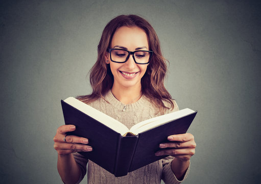 Cheerful woman reading smart book