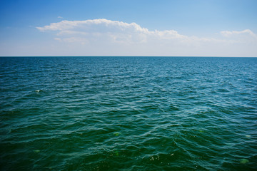 the blue ocean with dull clouds on a lovely sunny day