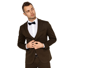 Man in tuxedo and vest in white shirt on white background