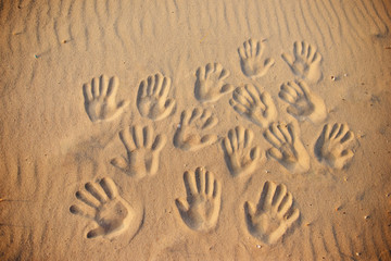 lots of hand prints on the sand