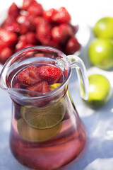 Fototapeta na wymiar Strawberry lemonade drink, refreshing summer mojito with strawberries, lime and mint.