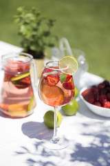 Strawberry lemonade drink, refreshing summer mojito with strawberries, lime and mint.