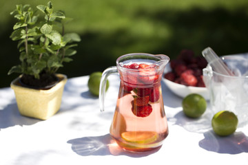 Strawberry lemonade drink, refreshing summer mojito with strawberries, lime and mint.
