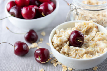  Breakfast of organic oatmeal with milk and fresh cherries