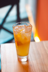 Refreshing citrus lemonade, summer drink. Ice tea with fresh lemon on wooden background. Refreshment beverage concept.