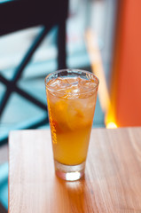 Refreshing citrus lemonade, summer drink. Ice tea with fresh lemon on wooden background. Refreshment beverage concept.