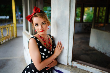beautiful young woman posing in retro dress