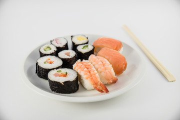 Japanese food Sushi on white plate with japanese chopsticks on white background