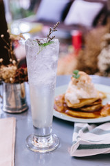 Lime soda with mint leaves and flowers on the top.