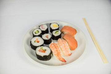 Japanese food Sushi on white plate with japanese chopsticks on white background