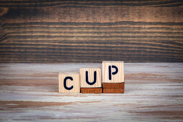 cup. Sports competitions, success at work or achievements in training. Wooden letters on the office desk, informative and communication background