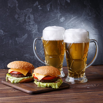 Picture of two hamburgers, glasses with beer