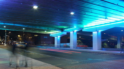 Time lapse under Neon lit bridge