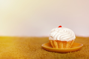 Cake on a plate. On green grass on a white background.
