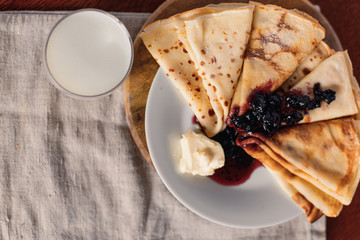 Thin pancakes for breakfast. Russian bliny. Maslenitsa. Pancakes on the white plate.