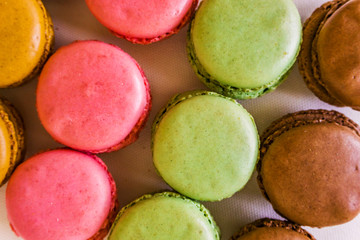Concept sweets, enjoyment of the senses. Close up of French macaroons on a colorful background. Shallow depth of focus.