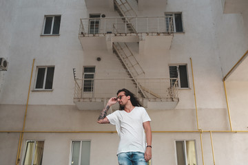 Stylish man posing on building background