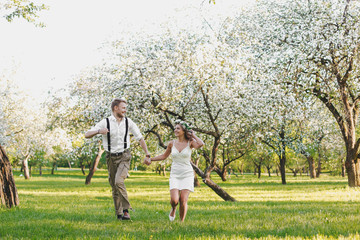 Fototapeta premium Happy couple. Loving couple enjoying in moments of happiness in the park. Love and tenderness, dating, romance. Lifestyle concept