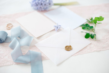 wedding invitation card as a decorated letter with flowers and ribbons top view