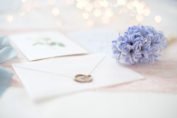 wedding invitation card as a decorated letter with blurred lights on background bokeh