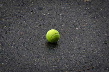 tennis ball stay on the asphalt