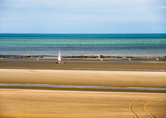 Sand sailing at an endless beach in front of  a ship wreck in Bray-Dunes, France