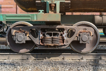 Fototapeta na wymiar Crop wheel of metal rusty wagon