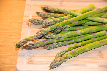 Fresh asparagus on wooden background