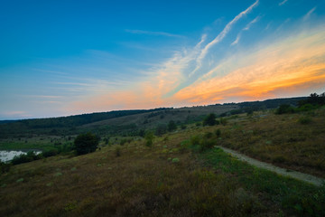Naklejka na ściany i meble Mountains during sunset. Beautiful natural landscape in the summer time.