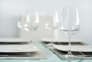 Table setting with a wine glasses, cutlery and plates
