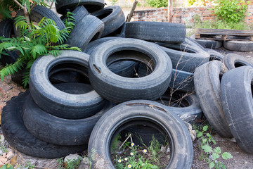 old worn tires are a big pile in a landfill