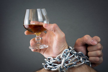 Hands chained together Fists of man in chains