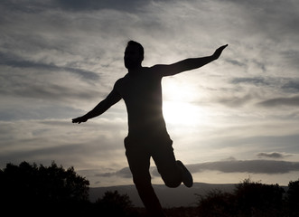 Fototapeta na wymiar Silhouette of a man running in the countryside