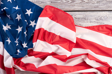 American flag on wooden table. Crumpled USA flag on vintage wooden background.