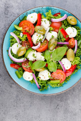 Vegetable salad with cheese mozzarella, tomatoes, basilikum and spice.