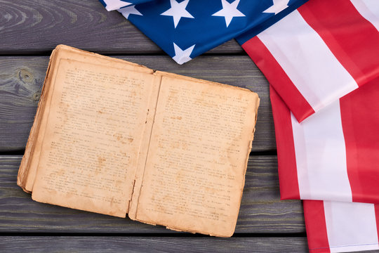 USA Flag And Old Opened Book. Constitution Of United States Of America. USA Flag And Bible. America And Religion.