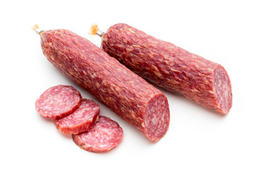 Salami smoked sausage, basil leaves and peppercorns isolated on white background.