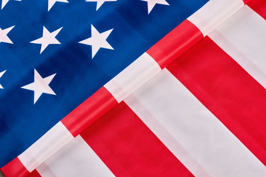 American flag background. Close up folded satin flag of the USA. Happy Independence Day. Idea for banner.