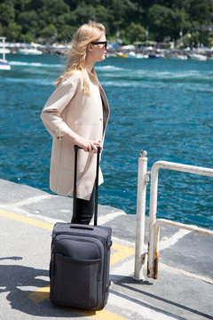 Young blond woman waiting for the ferry