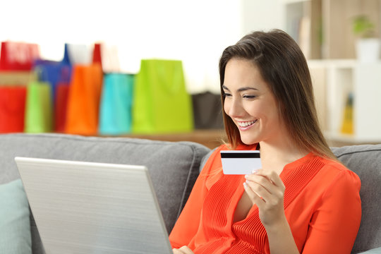 Smiley woman paying on line with credit card