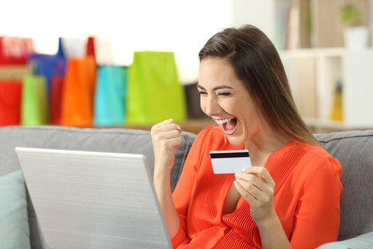 Excited shopper finding offers on line at home