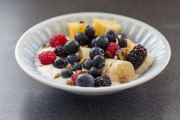 Plate of mixed fruits with yogurt