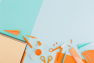 School flat lay design, desk. Back to school concept blue supplies over pastel green background.