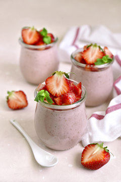 Homemade strawberry mousse in a vintage glass jar.