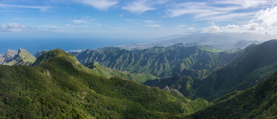 Naklejka na ściany i meble Majestic panoramic view of the Roques de Anaga. Beautiful mountain range and green valley with ocean on the background. Tenerife, Canary Islands.
