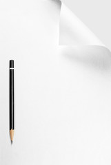 Blank sheet of paper with curled corner and pencil