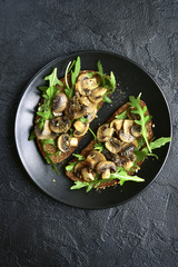 Rye toasts with sauteed mushrooms.Top view.