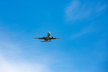 Fototapeta na wymiar Large passenger plane flying in the blue sky