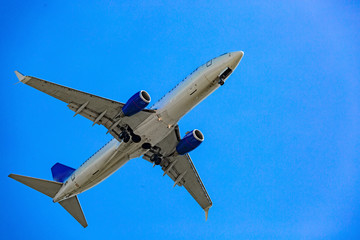 Large passenger plane flying in the blue sky