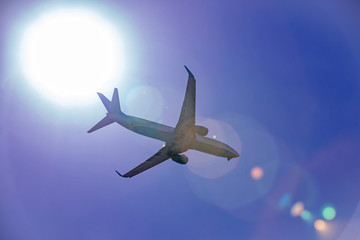 Naklejka premium Large passenger plane flying in the blue sky